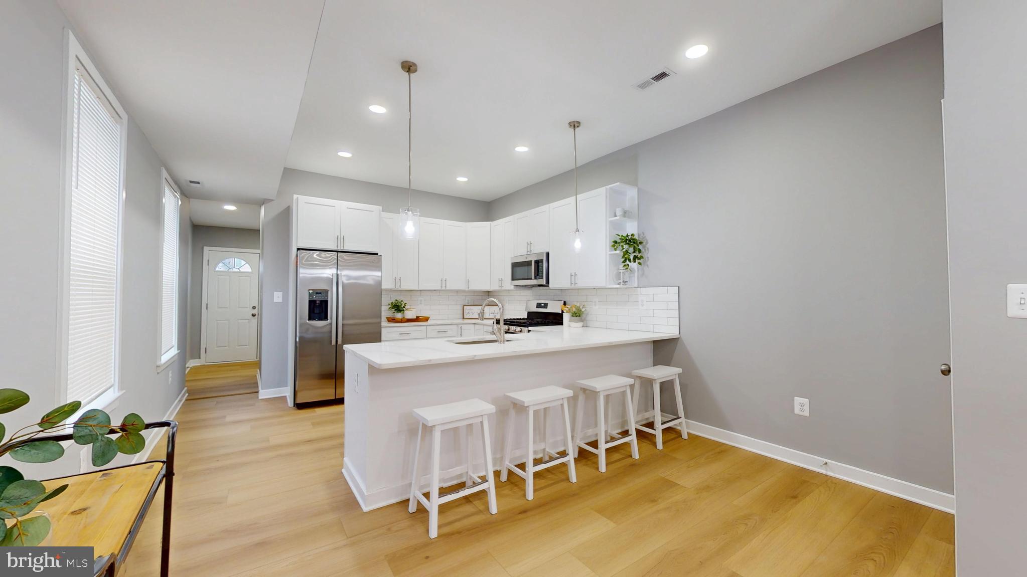 2519 East Fairmount Avenue Baltimore, MD 21224 - Photo 7 of 25 a large white kitchen with lots of counter space and appliances