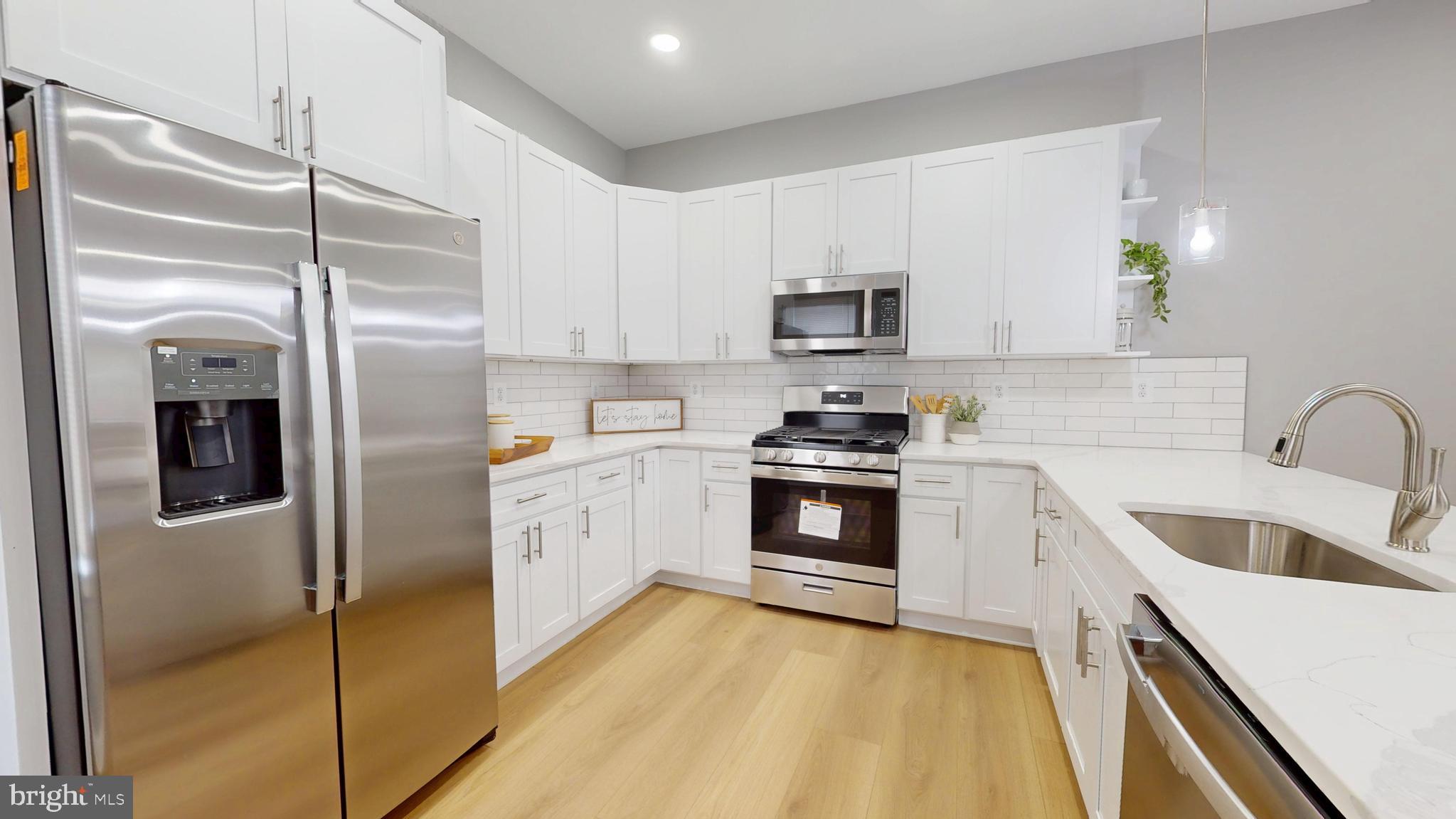 2519 East Fairmount Avenue Baltimore, MD 21224 - Photo 9 of 25 a kitchen with stainless steel appliances cabinets a sink and a stove