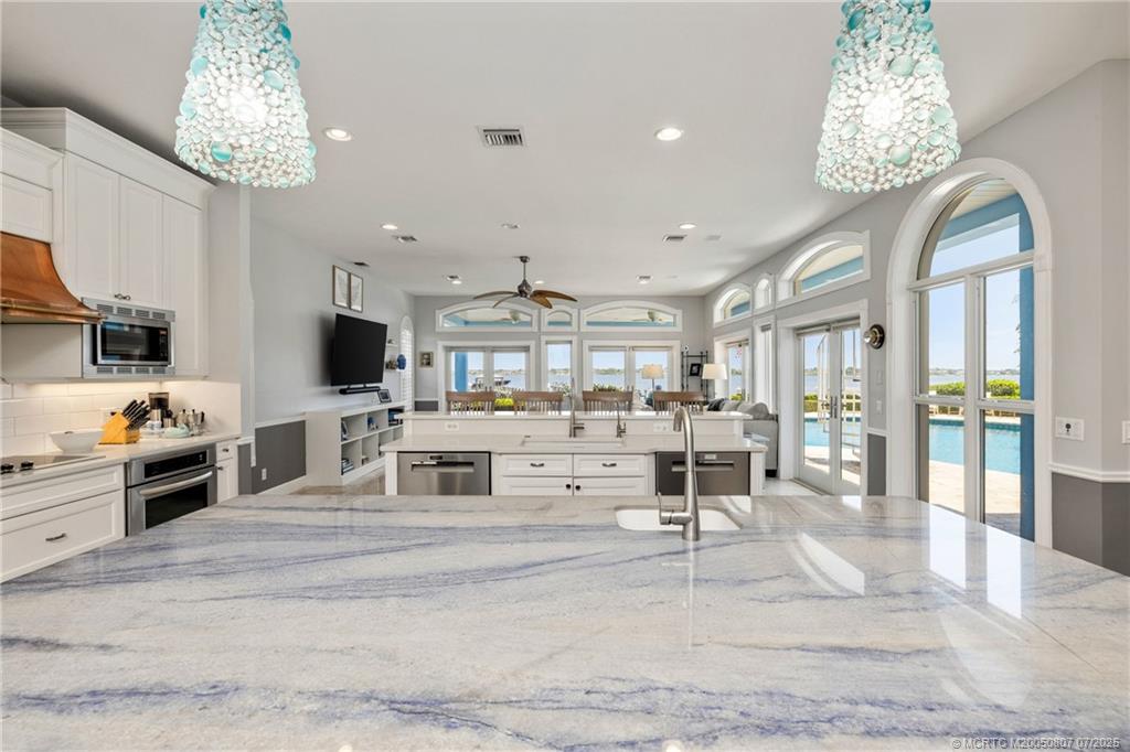 2051 Southeast Riverside Drive Stuart, FL 34996 - Photo 14 of 35 a living room with furniture and a chandelier