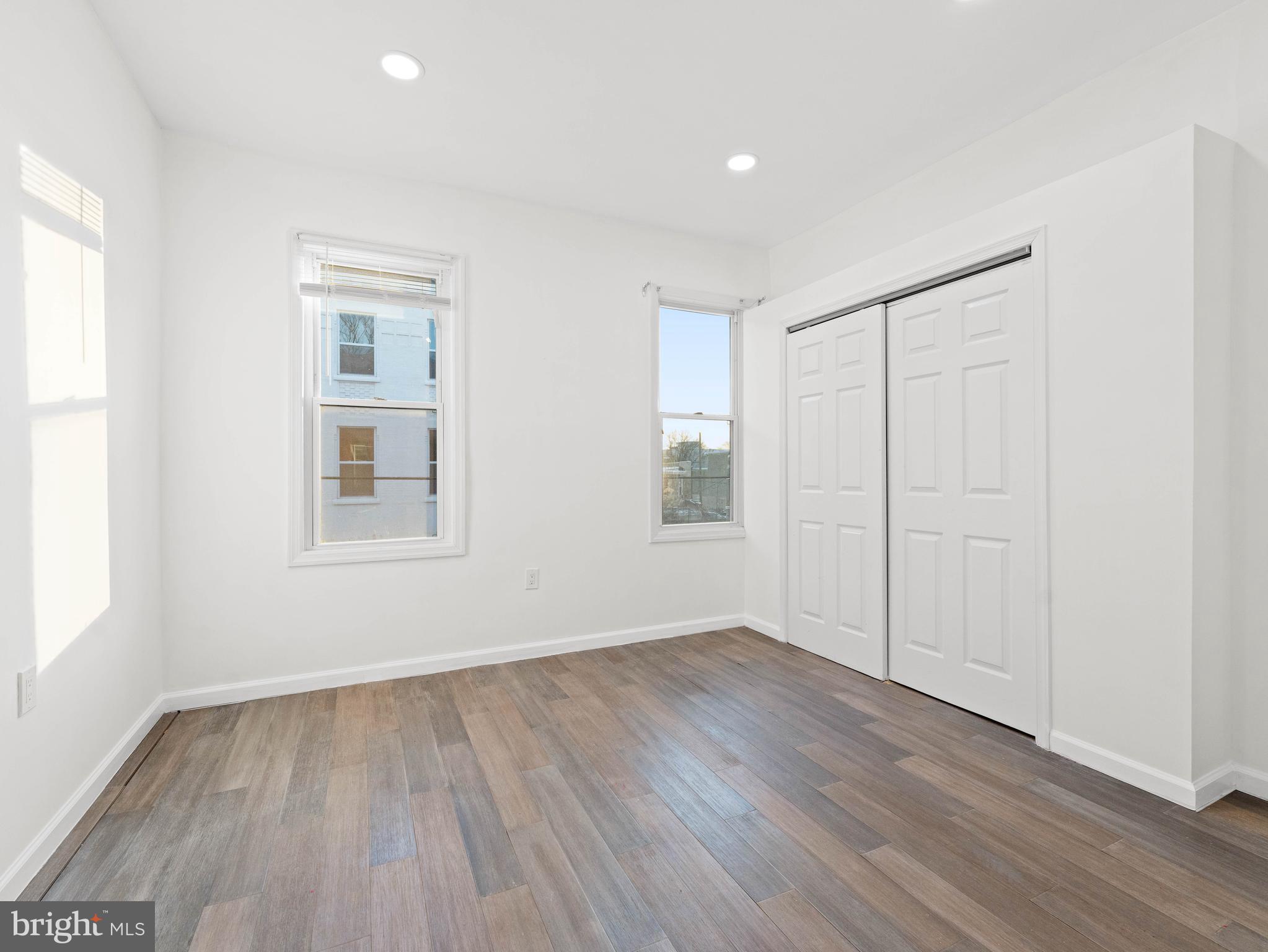 2443 Nicholas Street Philadelphia, PA 19121 - Photo 14 of 27 an empty room with wooden floor and windows