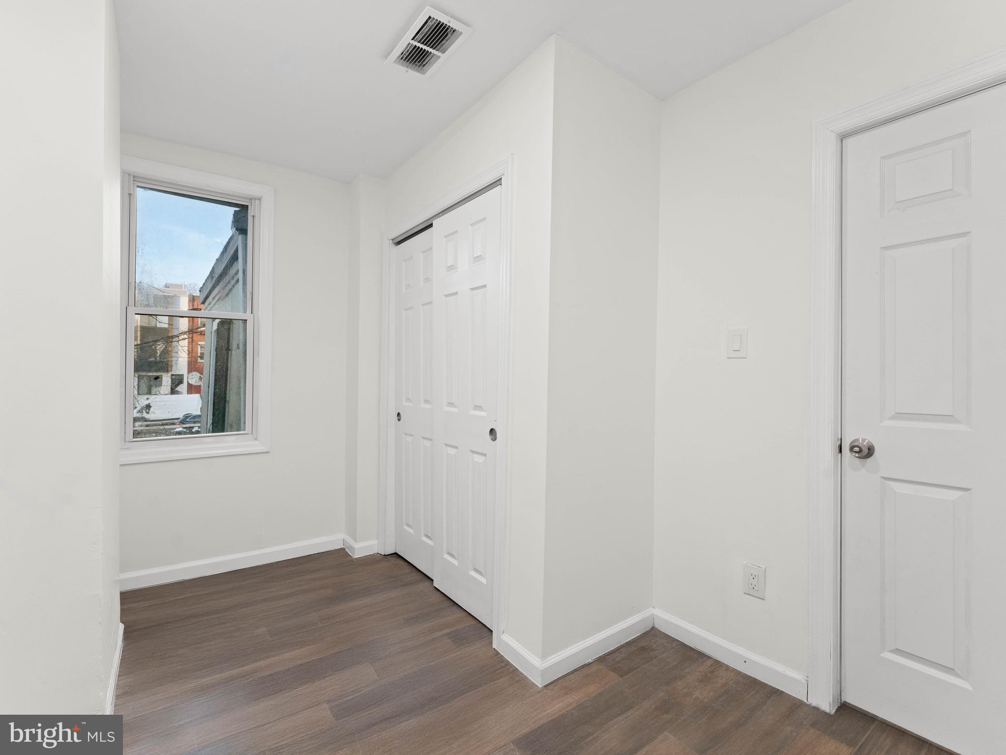 2443 Nicholas Street Philadelphia, PA 19121 - Photo 20 of 27 a view of an empty room with wooden floor and a window