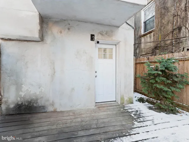 a view of a front door and wooden floor
