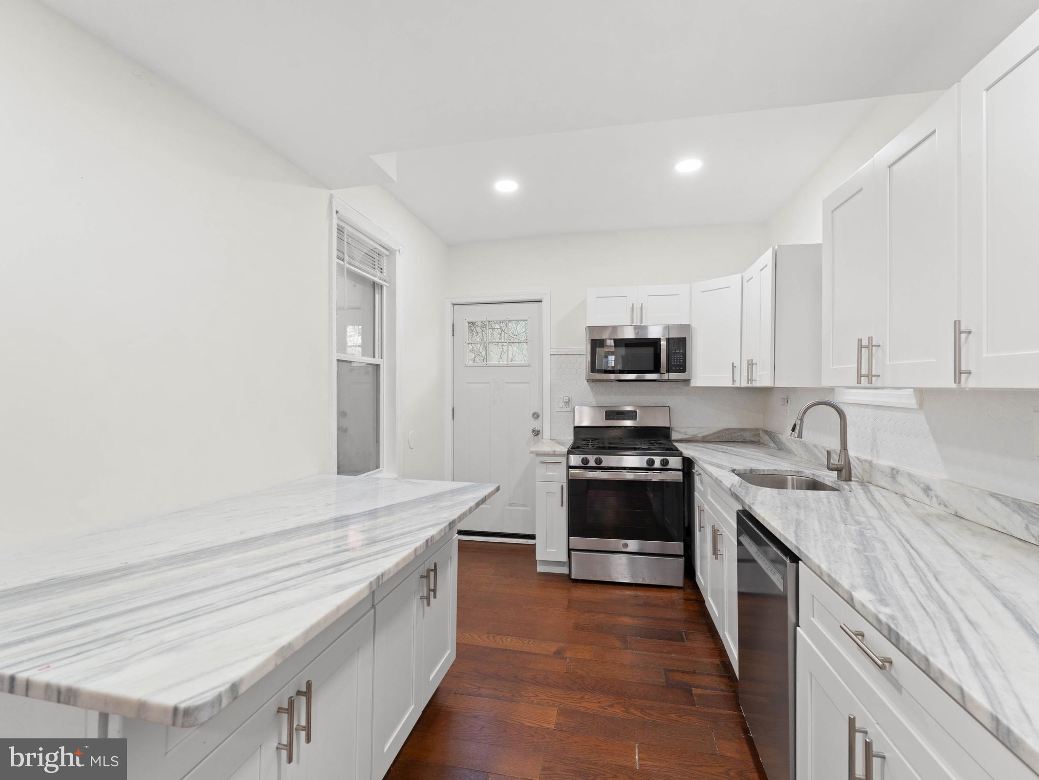 2443 Nicholas Street Philadelphia, PA 19121 - Photo 6 of 27 a large kitchen with a stove top oven