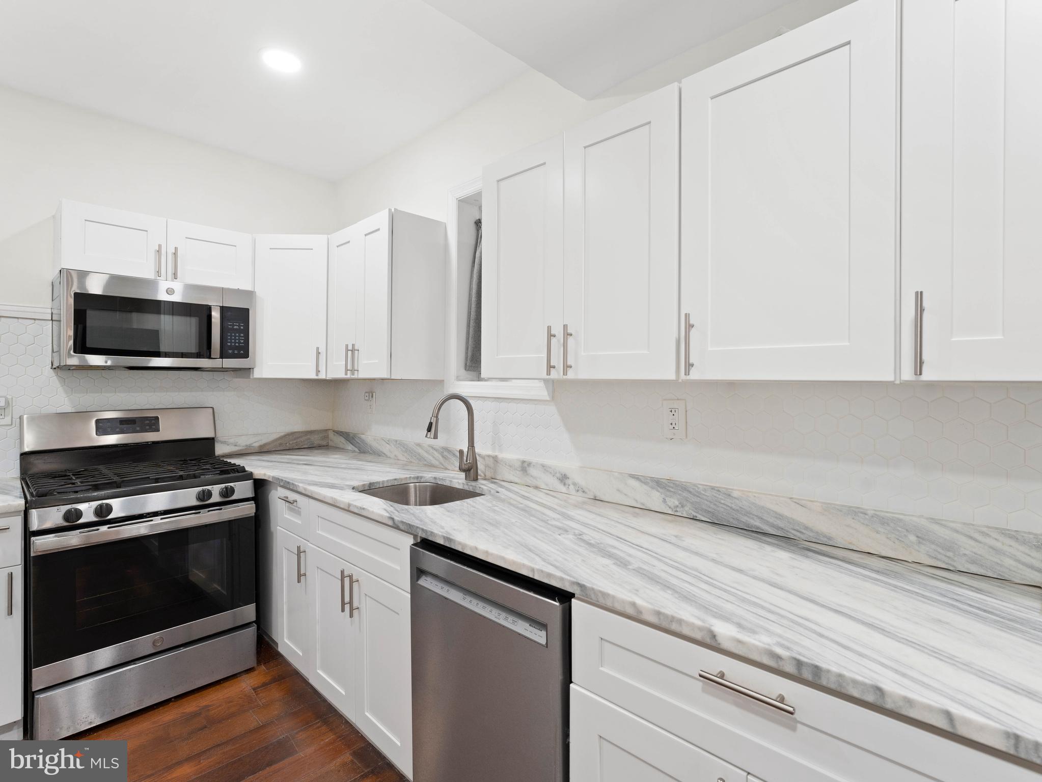 2443 Nicholas Street Philadelphia, PA 19121 - Photo 9 of 27 a kitchen with appliances a sink and cabinets