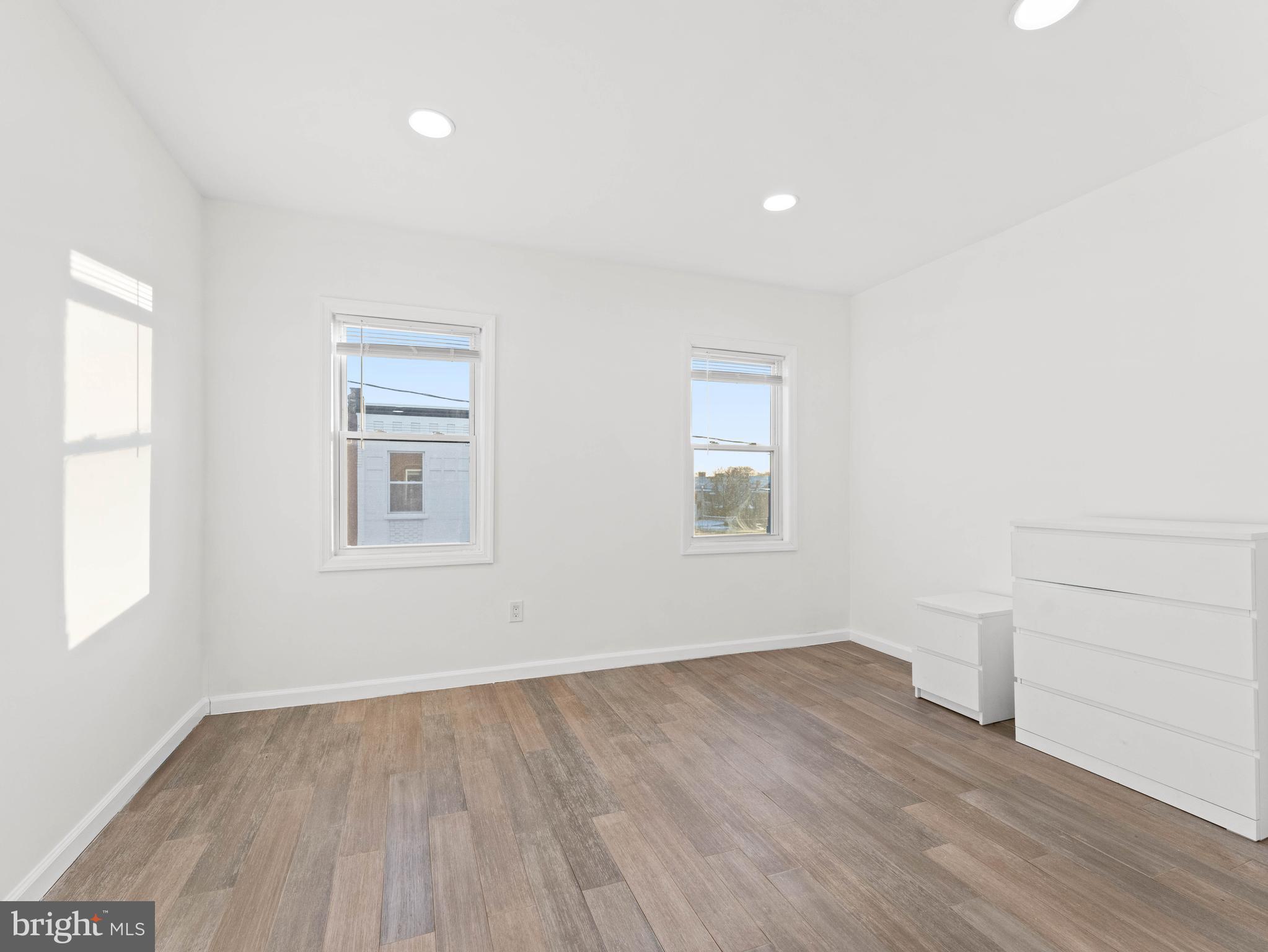 2443 Nicholas Street Philadelphia, PA 19121 - Photo 10 of 27 wooden floor in an empty room with a window