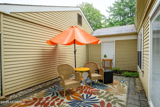 a backyard of a house with table and chairs