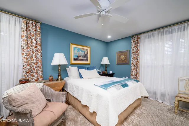 a bedroom with a bed and ceiling fan