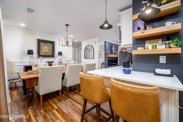a view of a dining room with furniture and chandelier