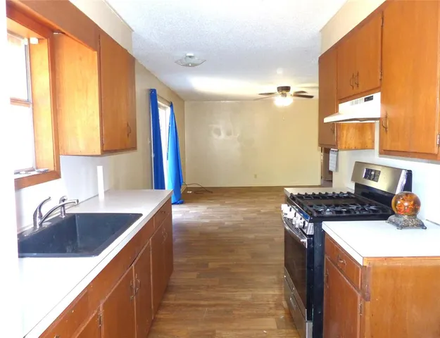 a kitchen that has a sink and a stove