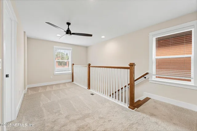a spacious bedroom with a bed and a chandelier