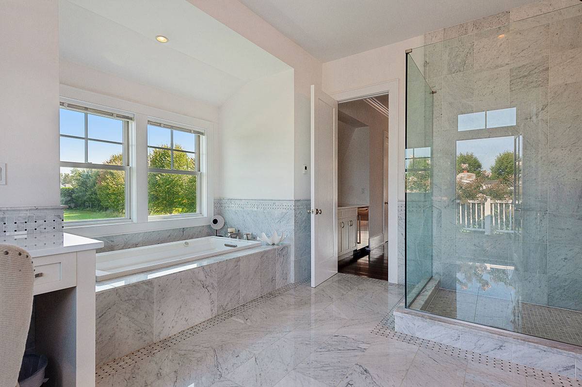 63 Newlight Lane Bridgehampton, NY 11976 - Photo 18 of 37 a spacious bathroom with a tub shower and a sink