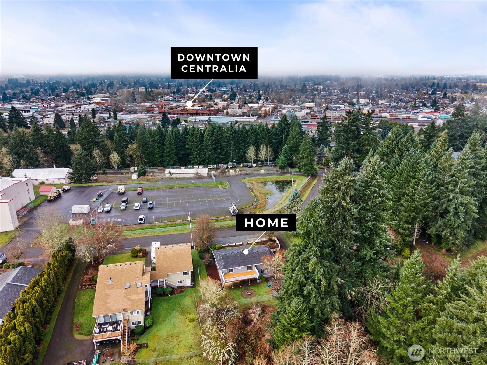 360 Byrd Street Centralia, WA 98531 - Photo 3 of 38 an aerial view of a swimming pool a yard and mountain view in back