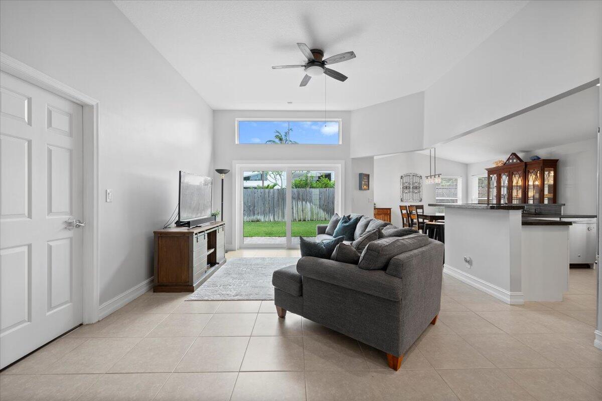 6377 Barbara Street Jupiter, FL 33458 - Photo 11 of 23 a living room with furniture a ceiling fan and a window
