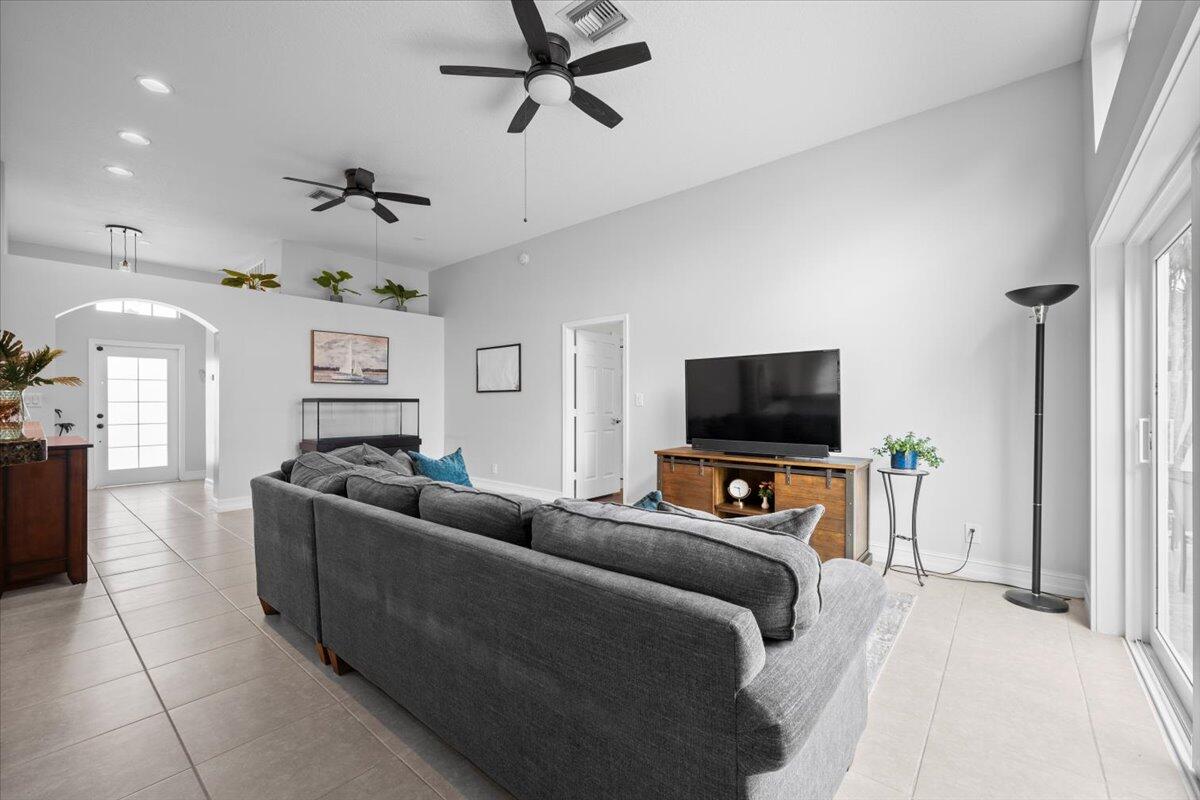 6377 Barbara Street Jupiter, FL 33458 - Photo 12 of 23 a living room with furniture and a flat screen tv