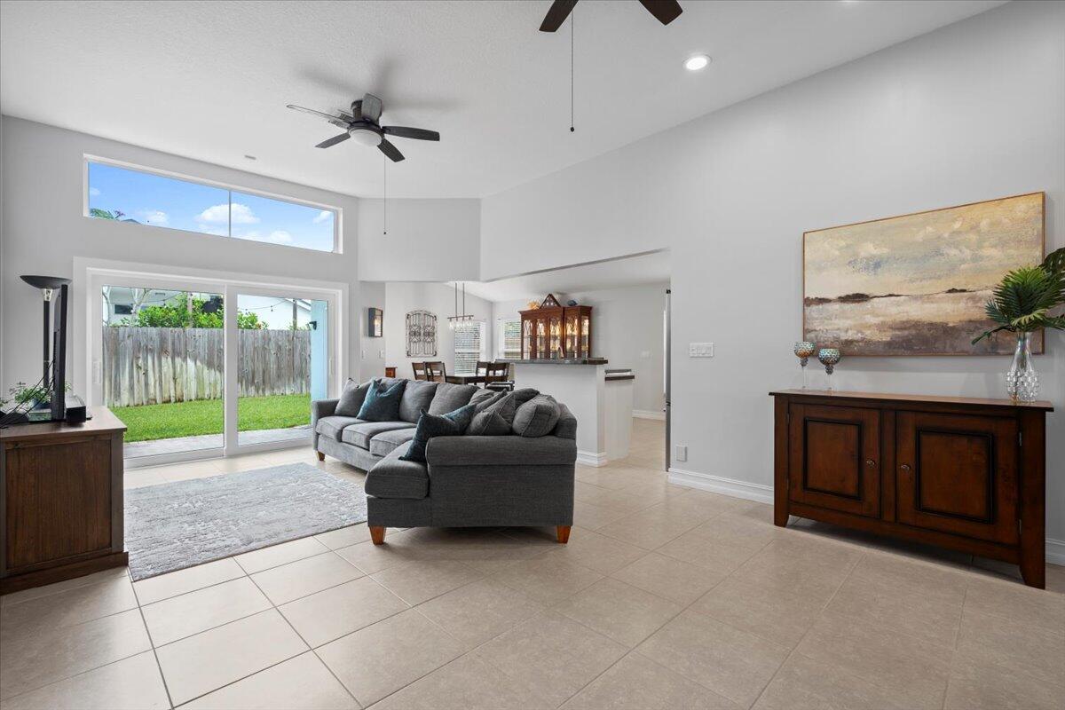 6377 Barbara Street Jupiter, FL 33458 - Photo 13 of 23 a living room with furniture and a flat screen tv
