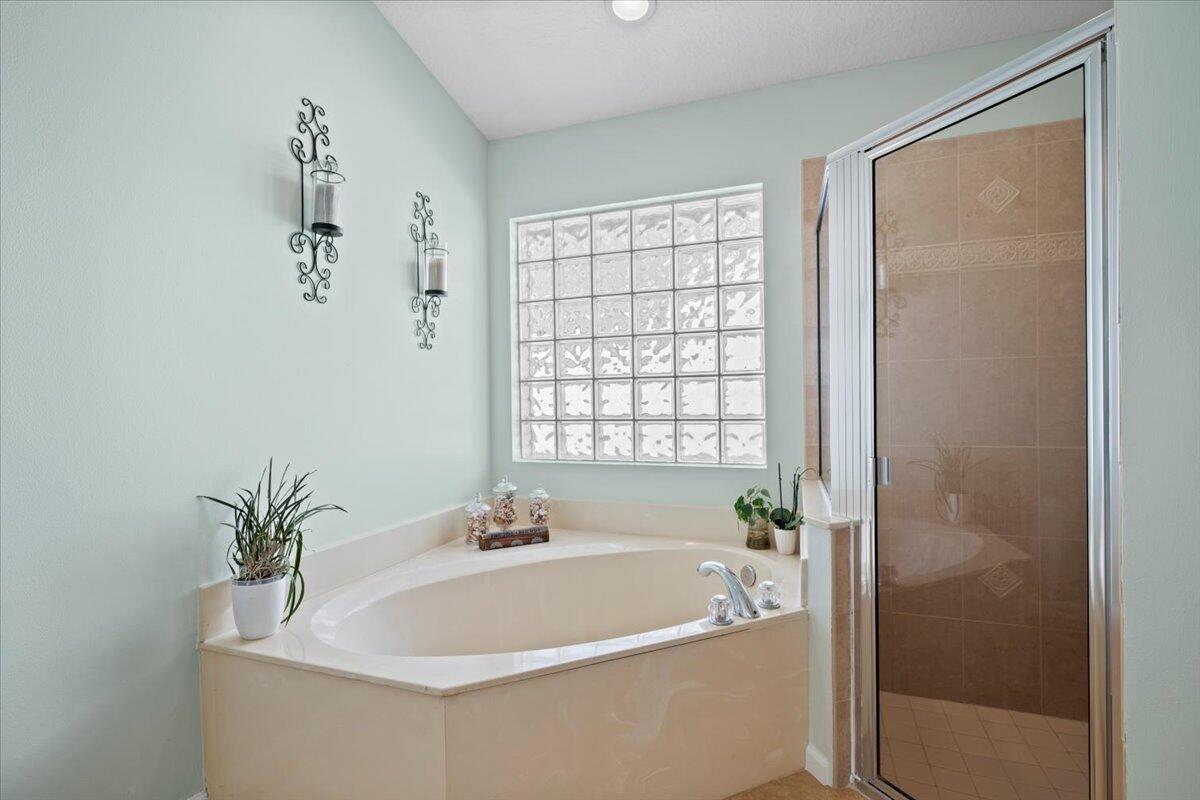 6377 Barbara Street Jupiter, FL 33458 - Photo 16 of 23 a white bath tub sitting next to a white sink