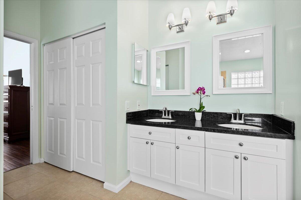 6377 Barbara Street Jupiter, FL 33458 - Photo 17 of 23 a bath room with two sink and a mirror