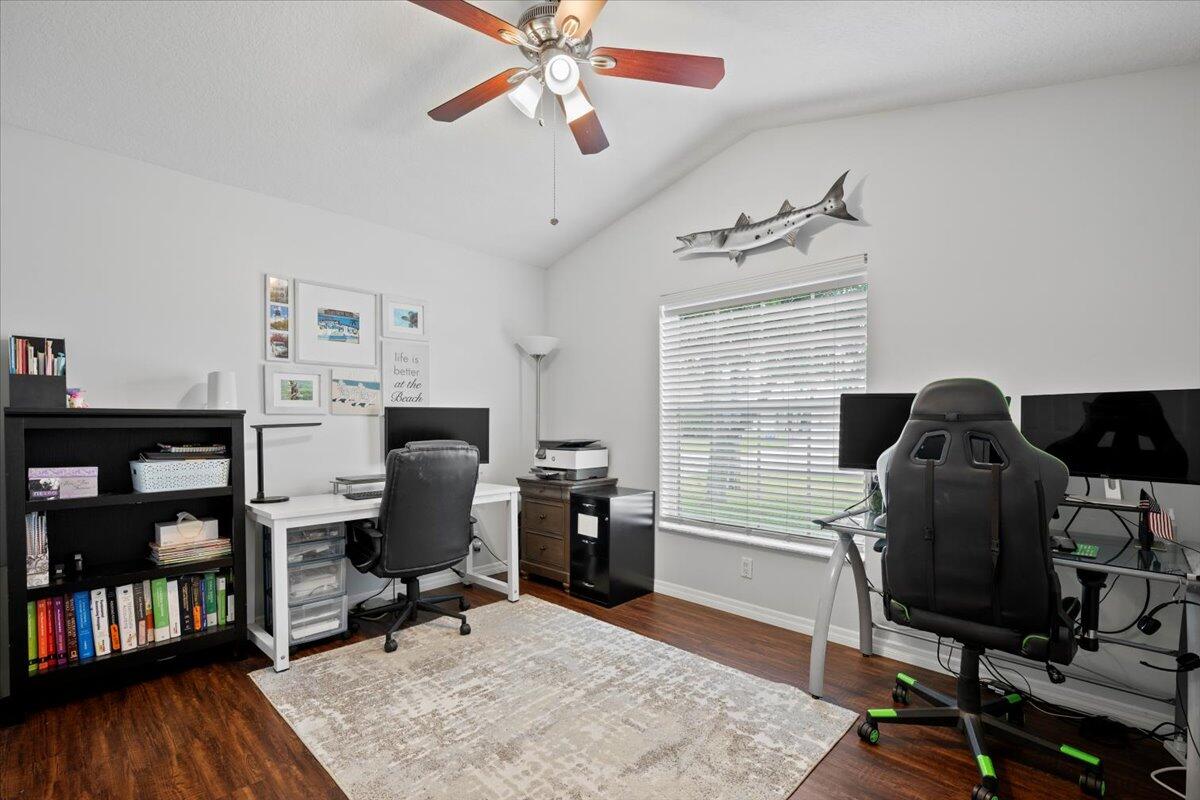 6377 Barbara Street Jupiter, FL 33458 - Photo 19 of 23 a workspace with furniture bookshelf and a window
