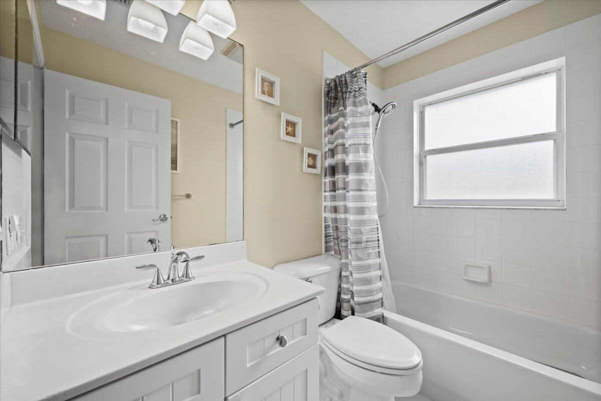 6377 Barbara Street Jupiter, FL 33458 - Photo 20 of 23 a bathroom with a sink a toilet and shower
