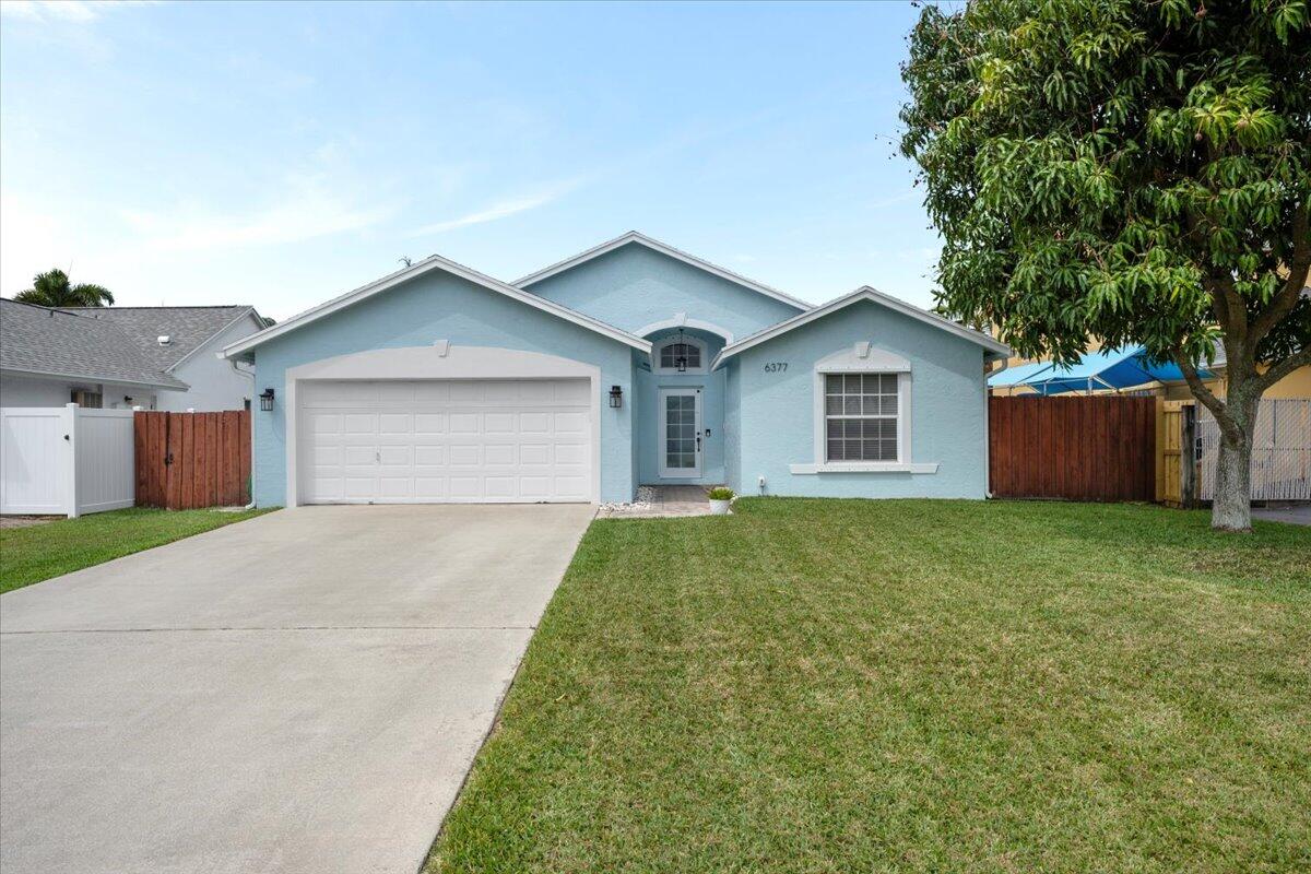 6377 Barbara Street Jupiter, FL 33458 - Photo 2 of 23 a view of outdoor space yard and garage