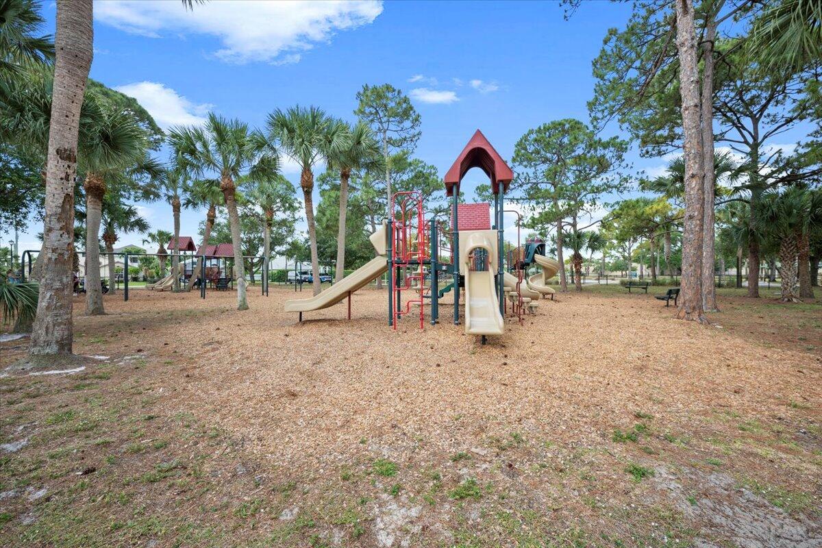 6377 Barbara Street Jupiter, FL 33458 - Photo 22 of 23 a view of a park with swings and slides