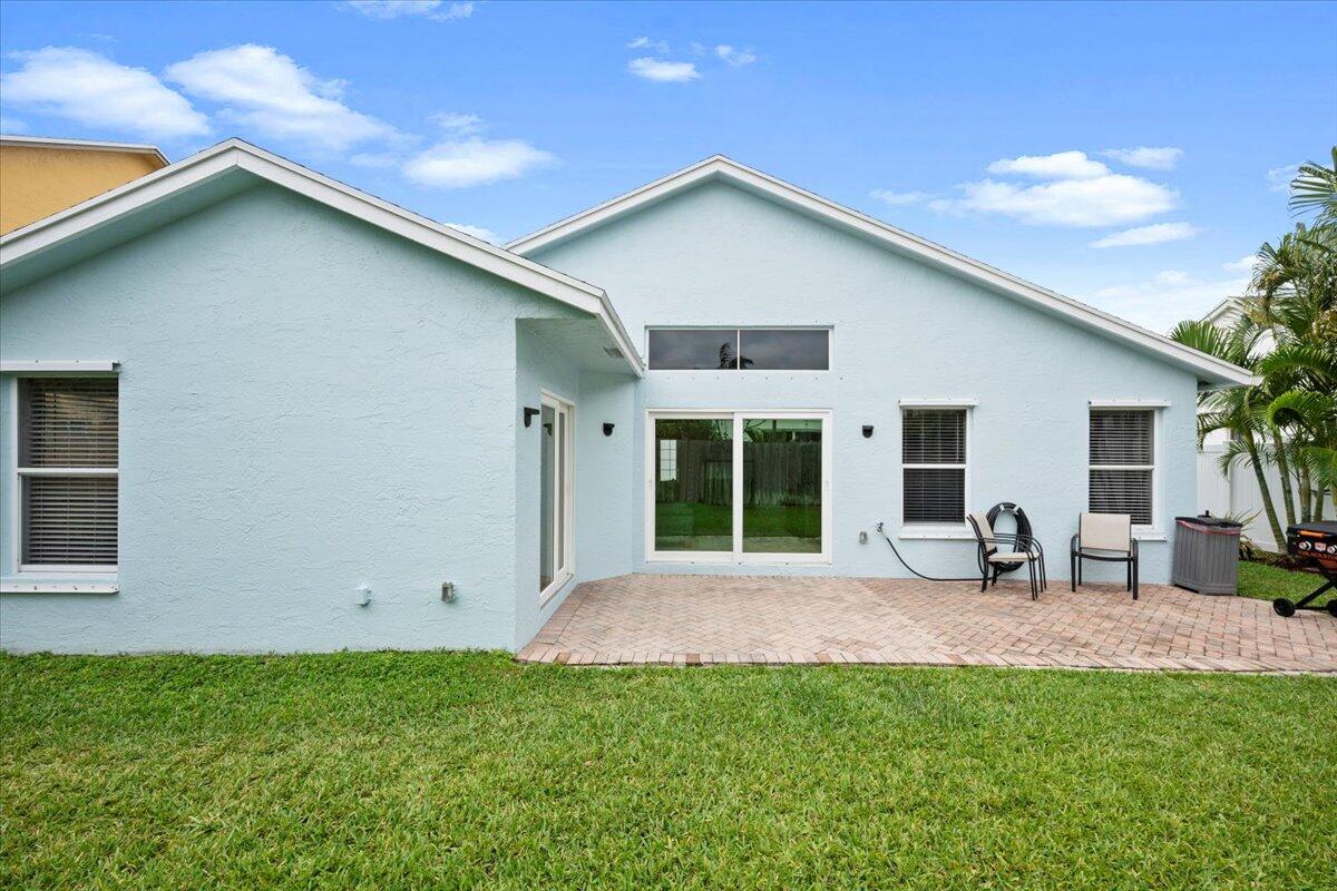 6377 Barbara Street Jupiter, FL 33458 - Photo 5 of 23 a front view of a house with patio