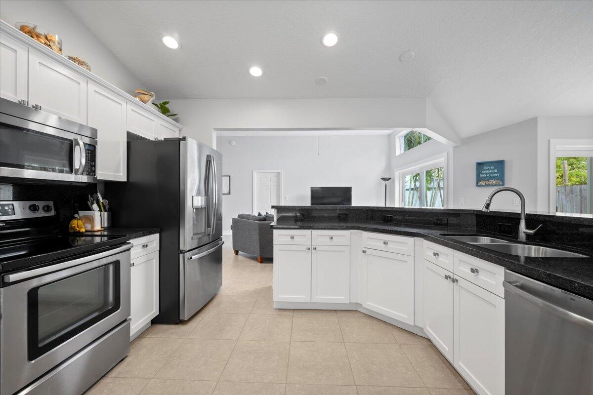 6377 Barbara Street Jupiter, FL 33458 - Photo 6 of 23 a kitchen with granite countertop stainless steel appliances and sink