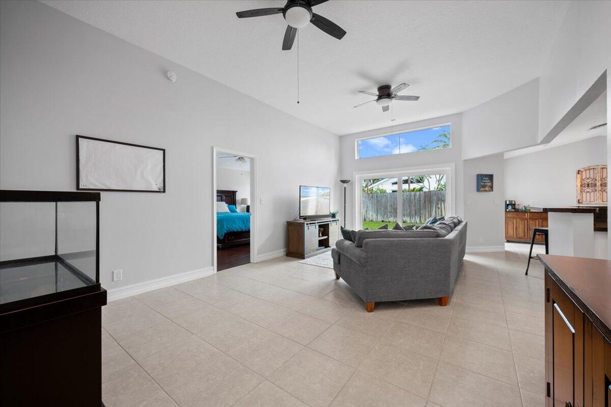 6377 Barbara Street Jupiter, FL 33458 - Photo 10 of 23 a living room with furniture and a flat screen tv