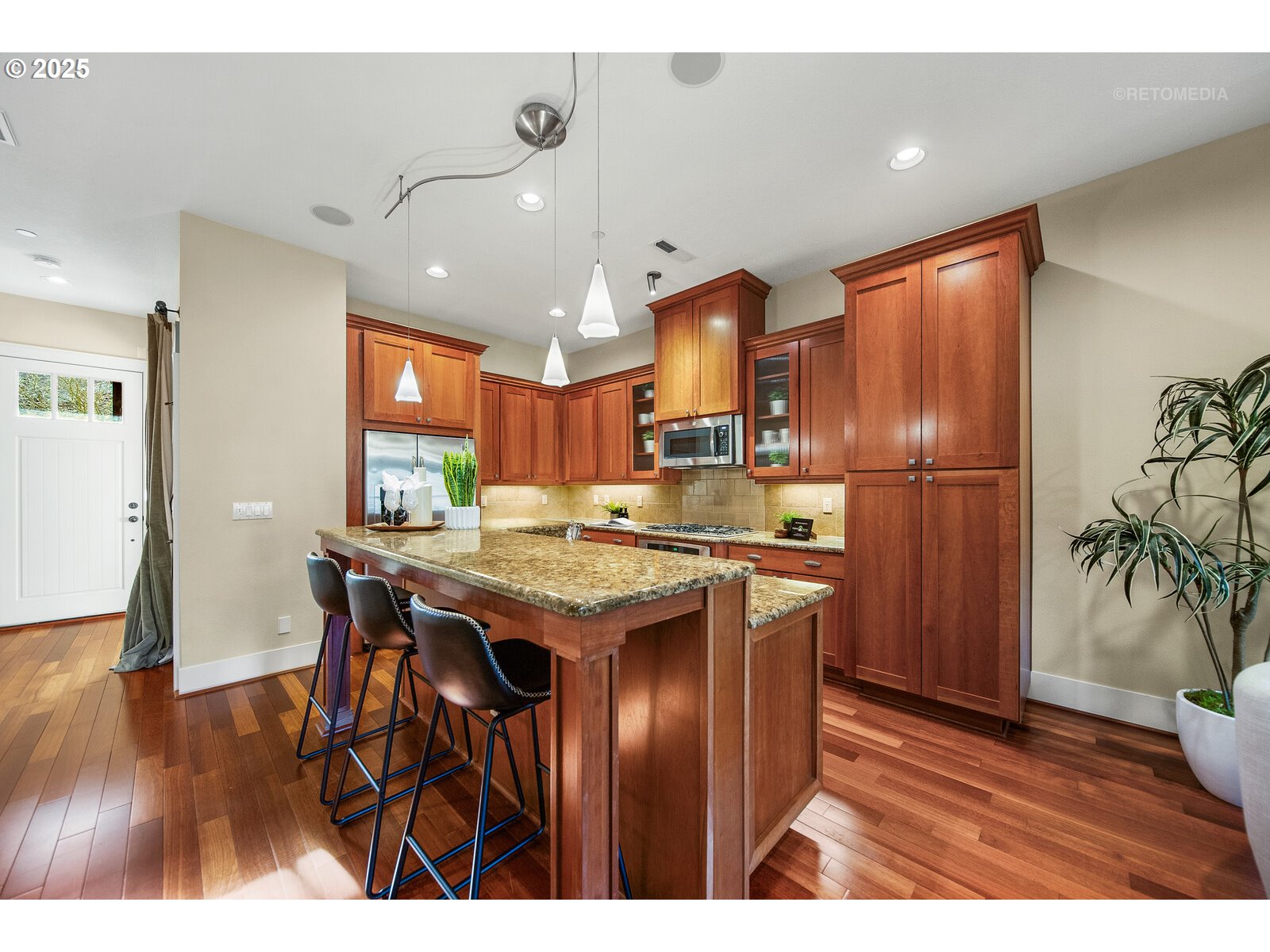 10225 Southwest Taylor Street Portland, OR 97225 - Photo 8 of 43 a kitchen with stainless steel appliances granite countertop a table chairs stove and wooden floor