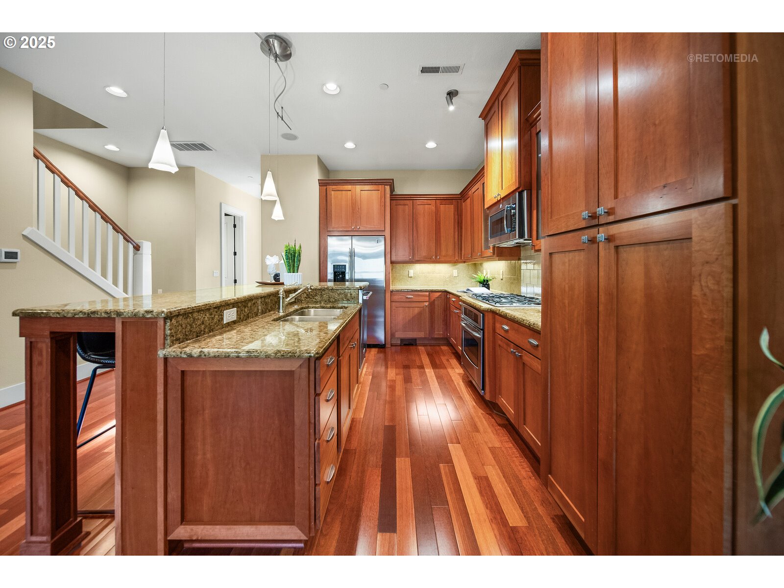 10225 Southwest Taylor Street Portland, OR 97225 - Photo 9 of 43 a open kitchen with stainless steel appliances granite countertop a refrigerator a oven and a sink with wooden floor