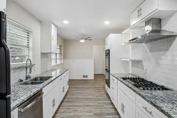 a kitchen with sink stove and refrigerator