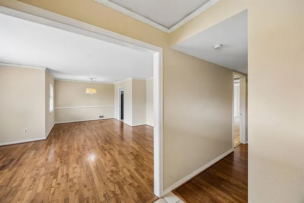 a view of a room with wooden floor and staircase