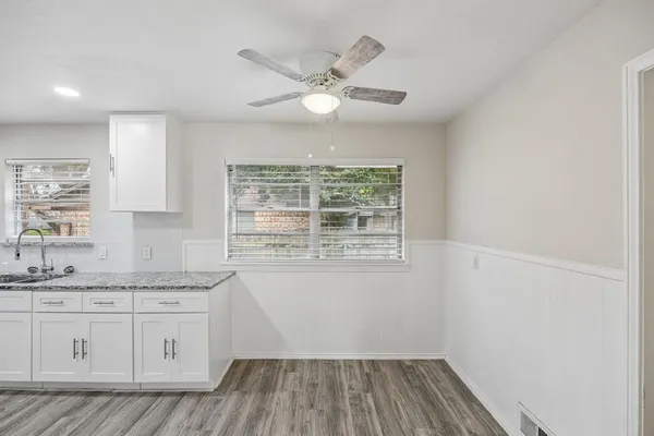 a kitchen with a sink window and cabinets