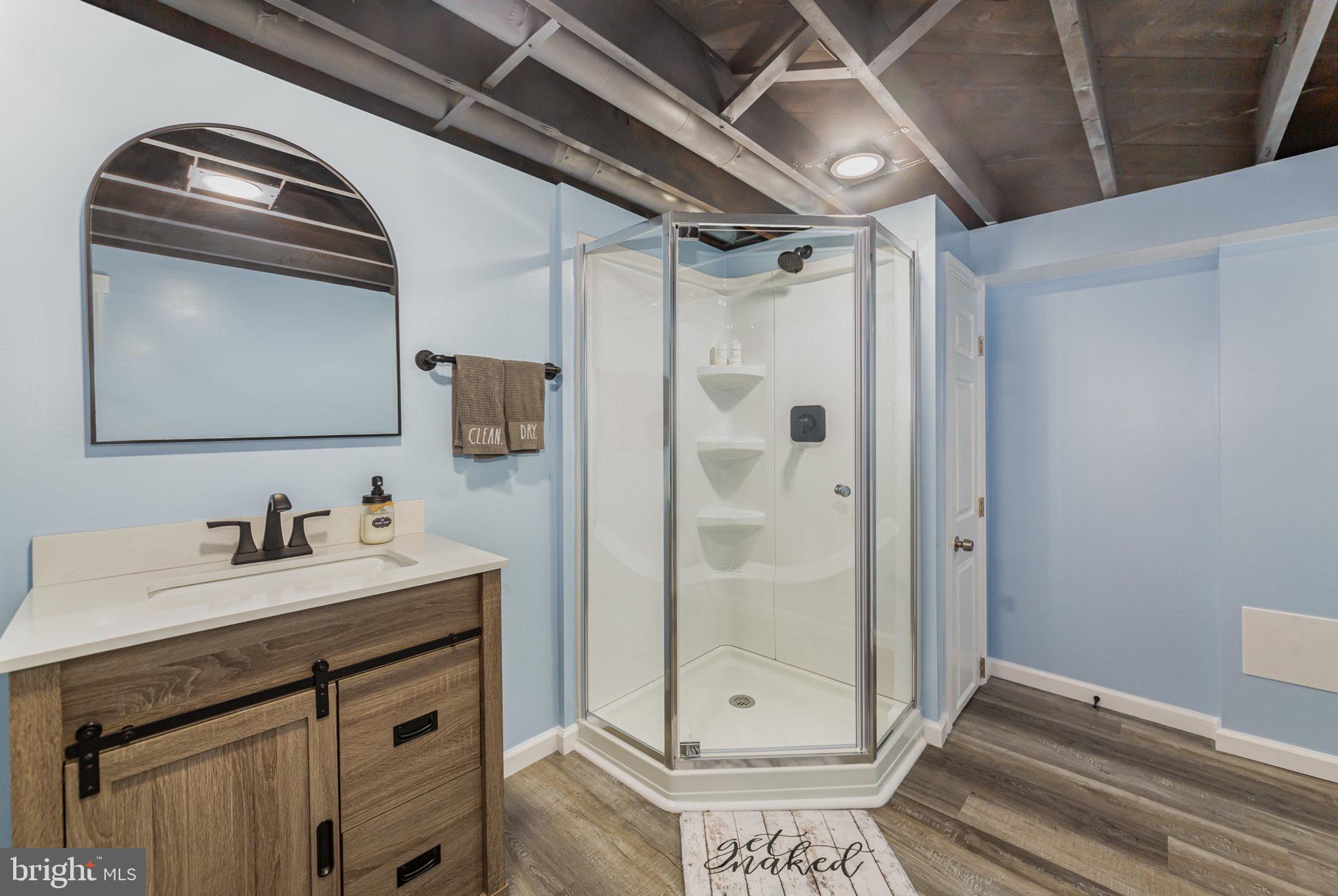 4116 Kahlston Road Baltimore, MD 21236 - Photo 26 of 37 a bathroom with a shower sink and mirror