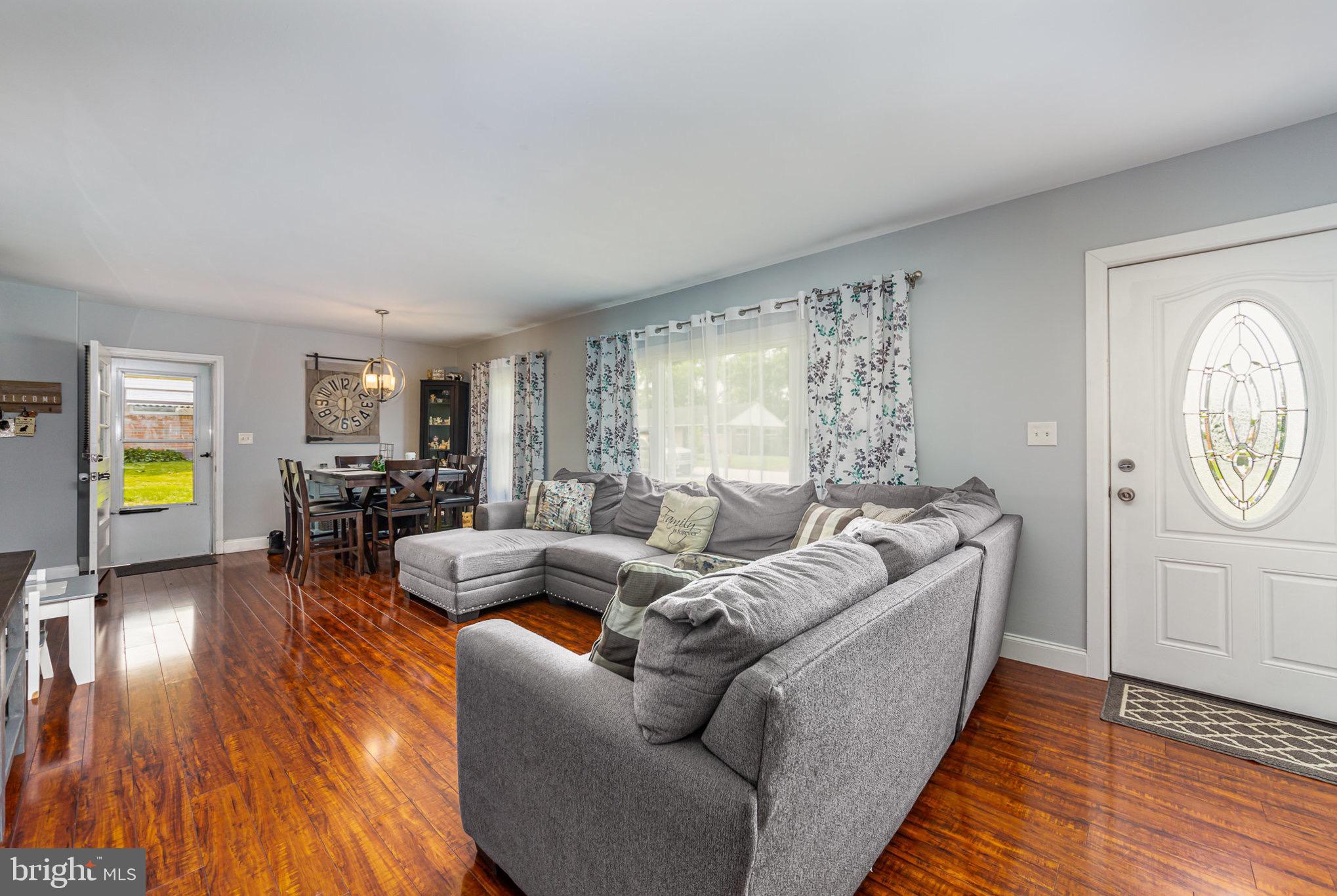 4116 Kahlston Road Baltimore, MD 21236 - Photo 8 of 37 a living room with furniture a chandelier and a wooden floor