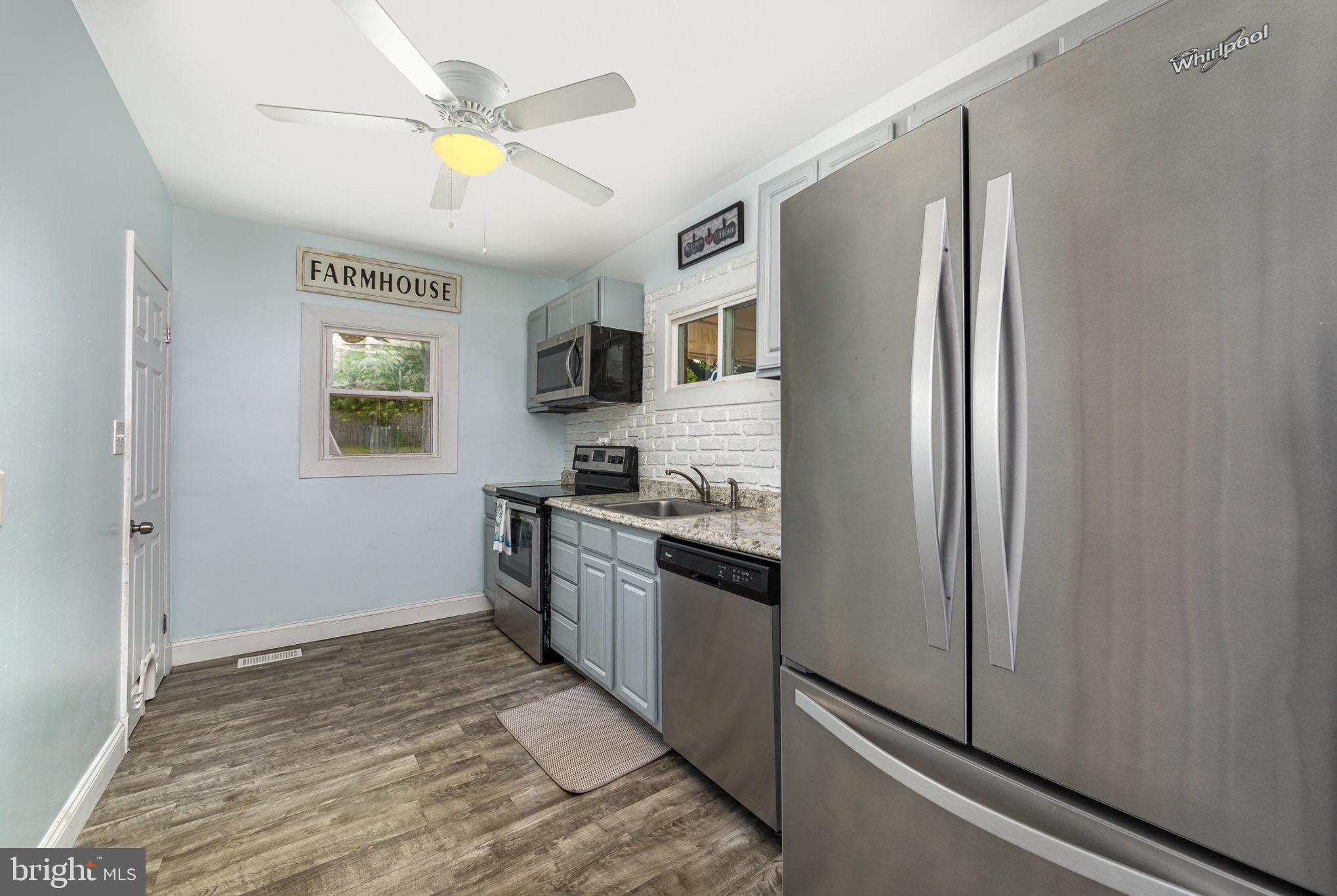 4116 Kahlston Road Baltimore, MD 21236 - Photo 10 of 37 a kitchen with stainless steel appliances granite countertop a refrigerator and a stove top oven
