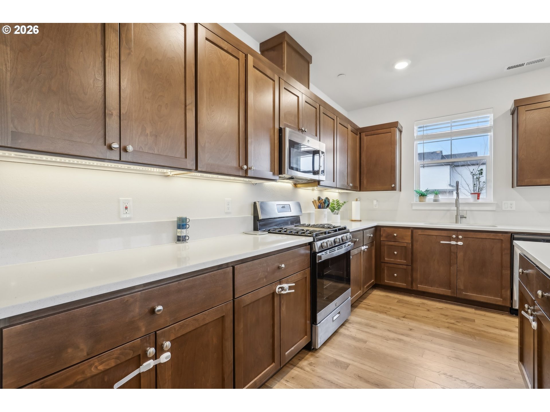 18436 Southwest Buckhorn Drive Beaverton, OR 97007 - Photo 14 of 35 a kitchen with a sink window and cabinets