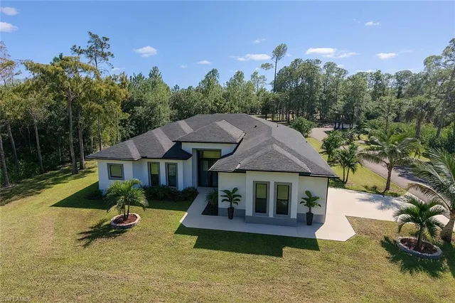 a house with swimming pool in front of it