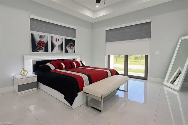 a bedroom with a bed and a painting on the wall