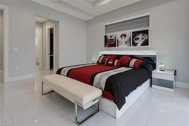 a bedroom with a bed and a television