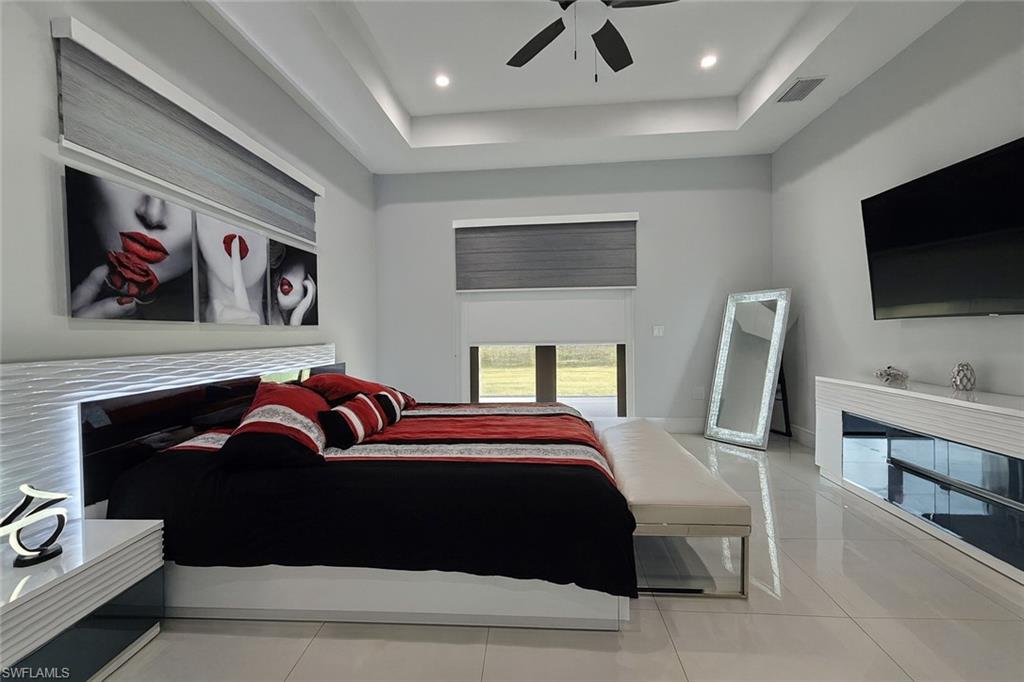 2330 4th Avenue Southeast Naples, FL 34117 - Photo 27 of 43 a bedroom with a bed and a television