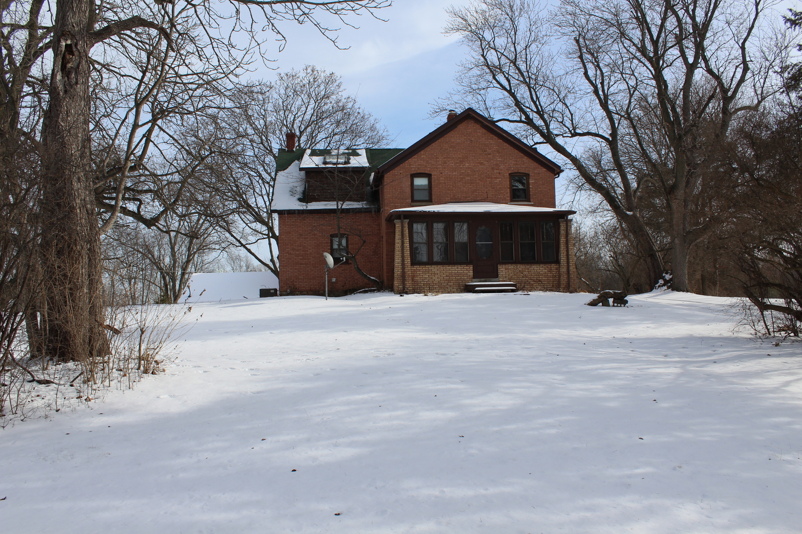 1245 Main Street Antioch, IL 60002 - Photo 35 of 44 a front view of a house with a yard covered in snow