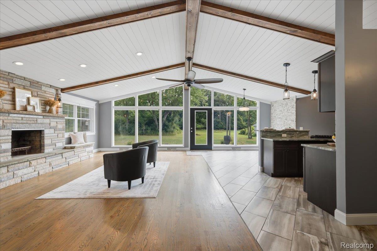 Stunning vaulted ceiling with wood beams and striking wall of windows