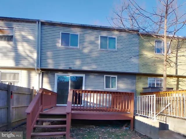a view of a house with wooden deck