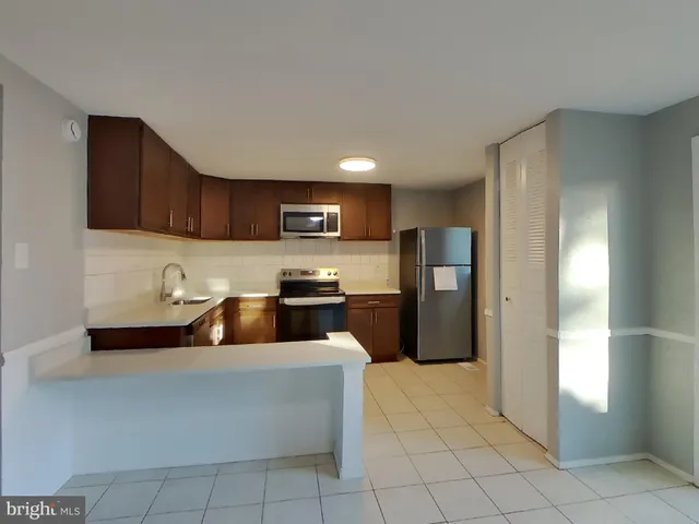 a kitchen with stainless steel appliances granite countertop a refrigerator sink and cabinets