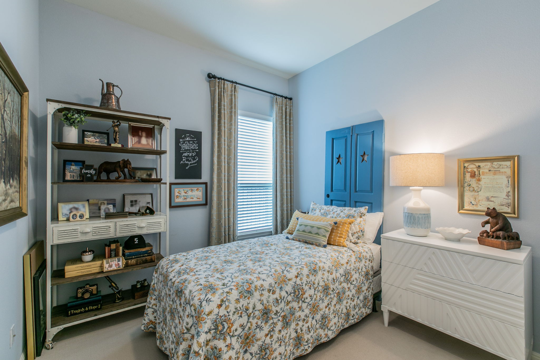 231 Simon Kyle, TX 78640 - Photo 17 of 29 Bedroom featuring a window with blinds and drapes, light blue walls, and light-toned carpeting
