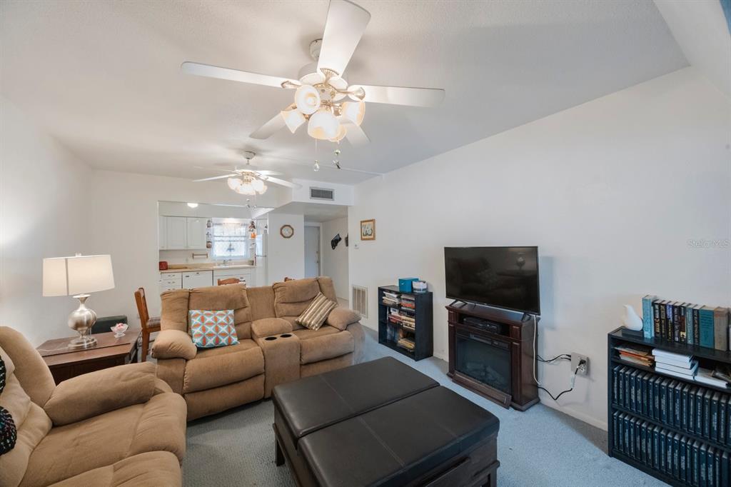 9945 47th Avenue North, Unit 203 St. Petersburg, FL 33708 - Photo 12 of 29 a living room with furniture and a flat screen tv