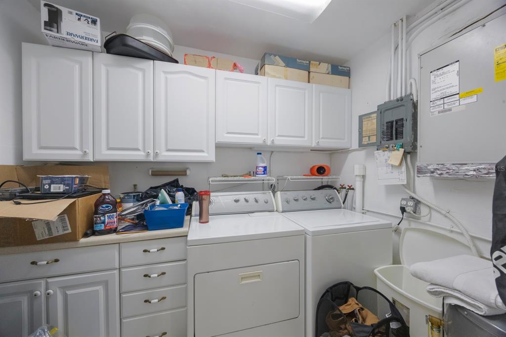 9945 47th Avenue North, Unit 203 St. Petersburg, FL 33708 - Photo 22 of 29 a kitchen with a sink a stove and cabinets