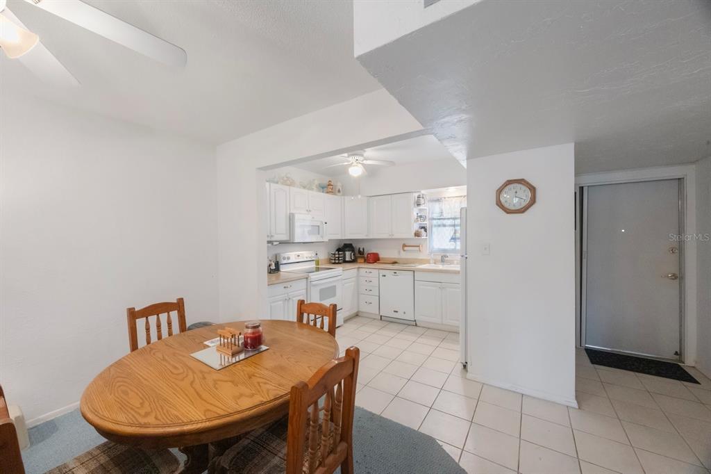 9945 47th Avenue North, Unit 203 St. Petersburg, FL 33708 - Photo 4 of 29 a kitchen with stainless steel appliances granite countertop a sink and a refrigerator