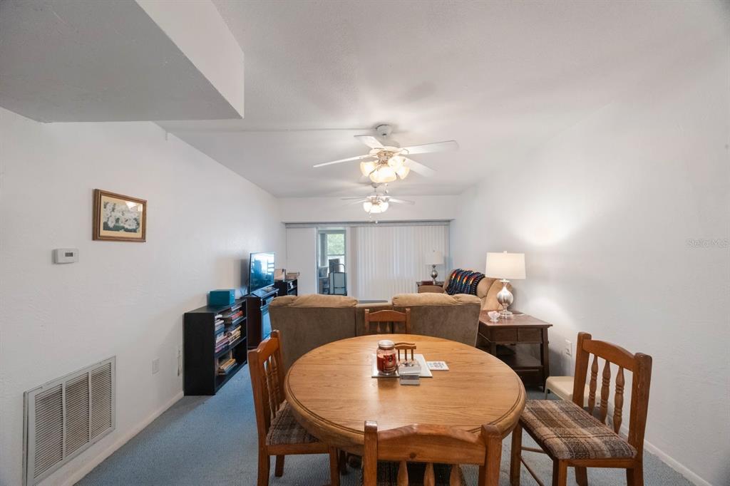 9945 47th Avenue North, Unit 203 St. Petersburg, FL 33708 - Photo 5 of 29 a view of a dining room with furniture